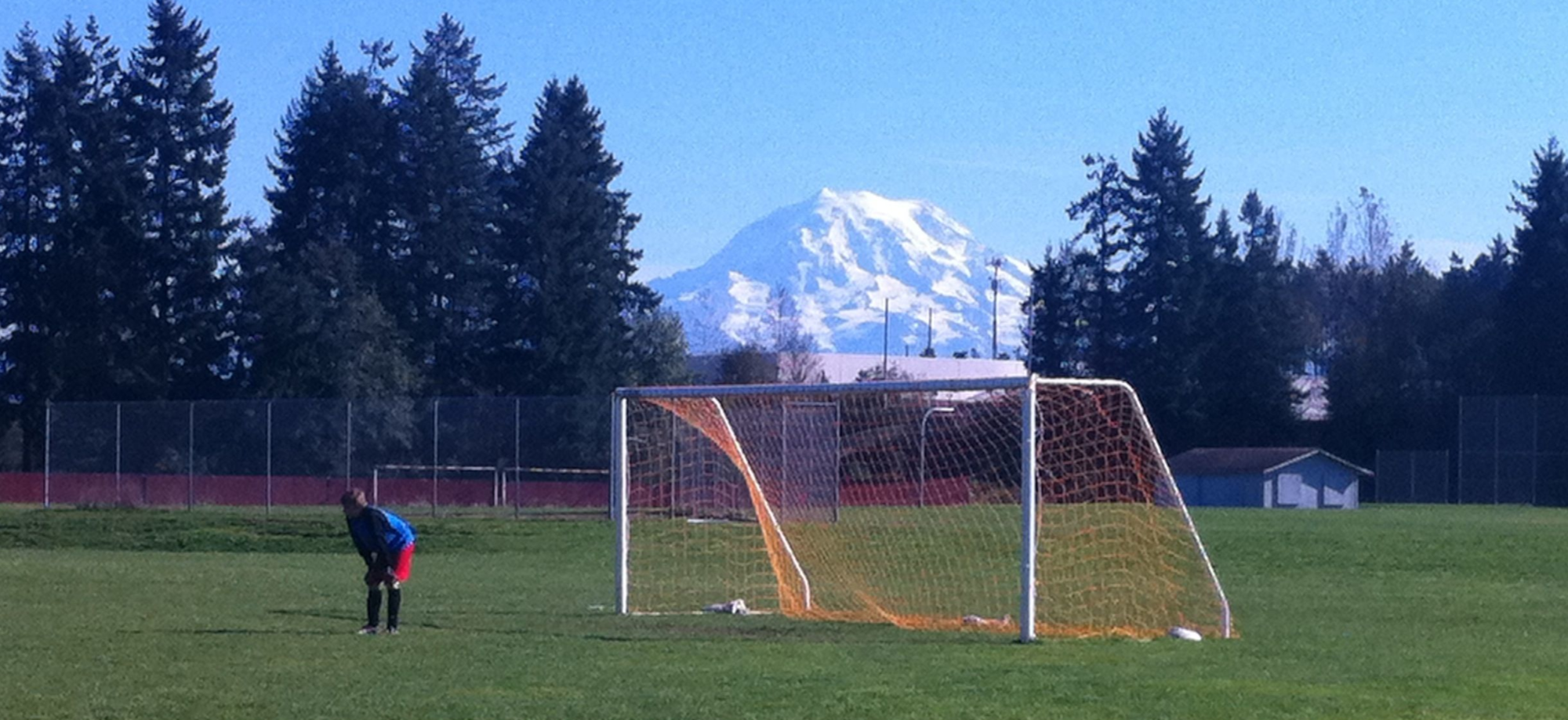 Soccer players shooting on a tended goal